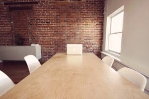 A wooden table in a conference room.