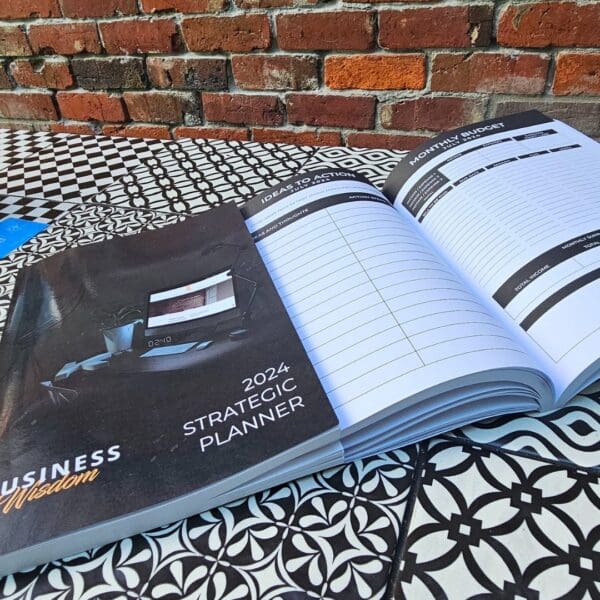 The Strategic Planner placed on a table near a brick wall.