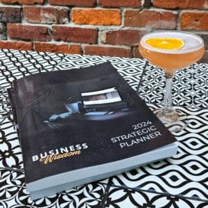 An arrangement of The Strategic Planner and book on a coffee table.