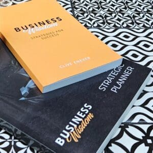 Two Tap into all the Business Wisdom you need with the Business Wisdom Package on a table next to each other.
